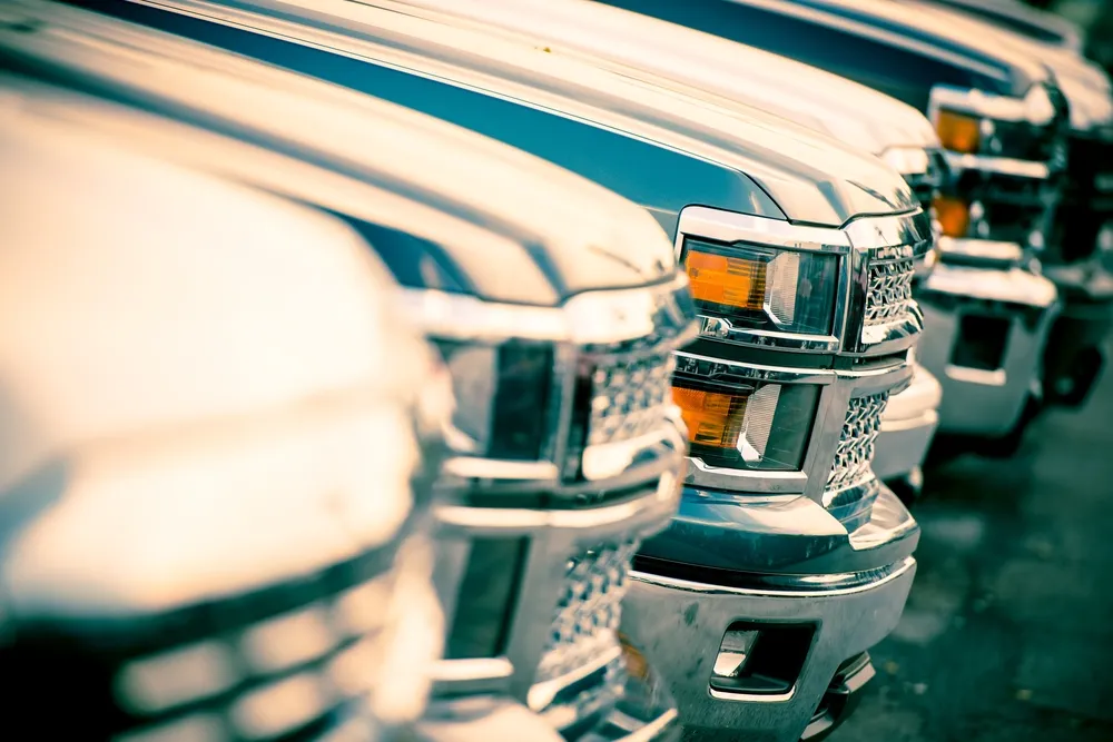 Front view of multiple diesel pickup trucks lined up, representing vehicles maintained and repaired through expert diesel repair services
