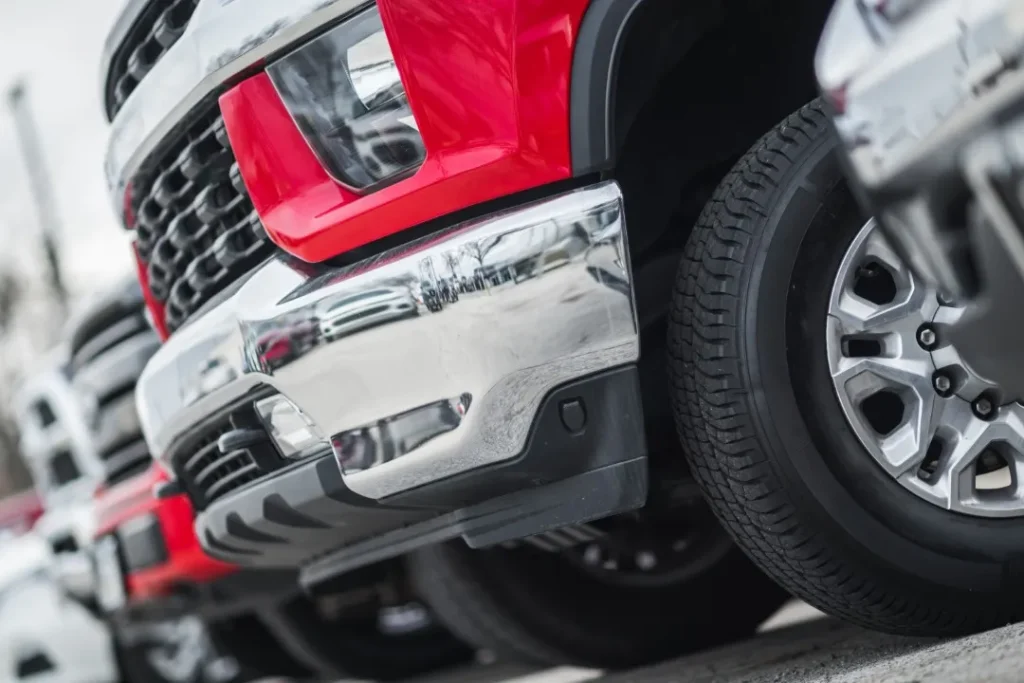 Red pickup truck bumper; close-up view. Diesel engine problems are difficult to spot from the outside.